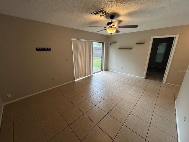 1309 Malone Ave, Spring Hill, FL 34606 - unfurnished room with visible vents, a ceiling fan, light tile patterned floors, baseboards, and a textured ceiling