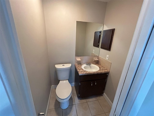 1309 Malone Ave, Spring Hill, FL 34606 - half bathroom with vanity, toilet, tile patterned flooring, and baseboards