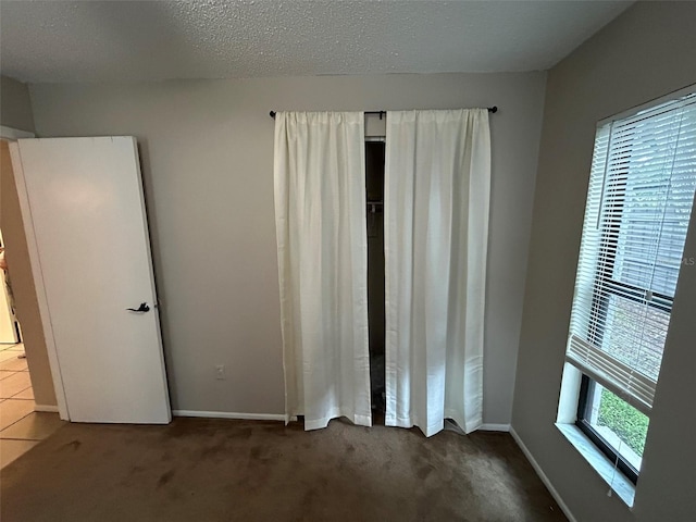 1309 Malone Ave, Spring Hill, FL 34606 - unfurnished bedroom featuring baseboards, carpet flooring, and a textured ceiling