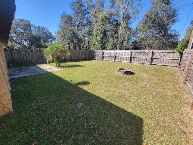 1309 Malone Ave, Spring Hill, FL 34606 - view of yard featuring a fenced backyard, a patio area, and an outdoor fire pit