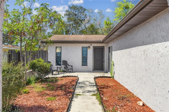 1309 Malone Ave, Spring Hill, FL 34606 - entrance to property with a patio, stucco siding, and fence