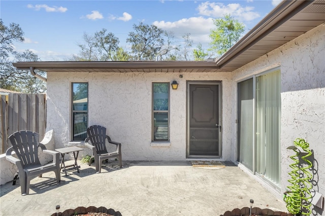 1309 Malone Ave, Spring Hill, FL 34606 - property entrance featuring a patio, stucco siding, and fence