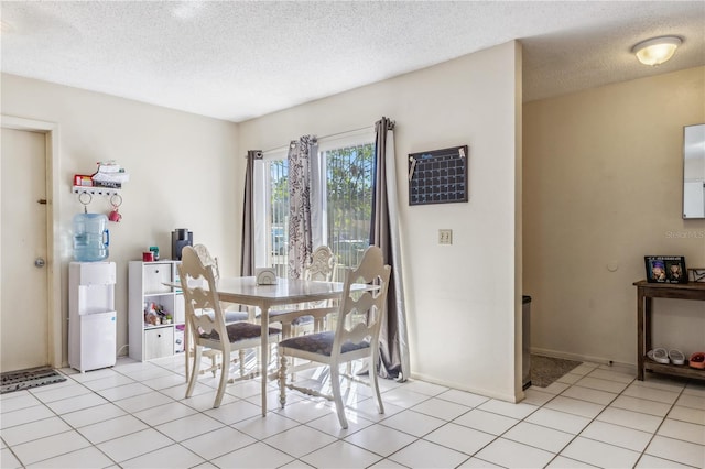 1309 Malone Ave, Spring Hill, FL 34606 - dining room featuring baseboards, a textured ceiling, and light tile patterned floors