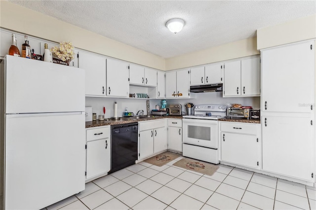 1309 Malone Ave, Spring Hill, FL 34606 - kitchen with dark countertops, under cabinet range hood, a textured ceiling, and white appliances