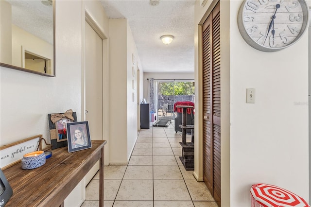 1309 Malone Ave, Spring Hill, FL 34606 - hallway with baseboards, a textured ceiling, and light tile patterned flooring