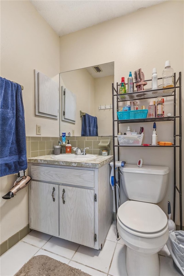 1309 Malone Ave, Spring Hill, FL 34606 - half bath featuring tile patterned flooring, toilet, vanity, and visible vents