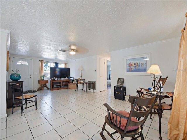 living room with visible vents, ceiling fan, a textured ceiling, and light tile patterned flooring