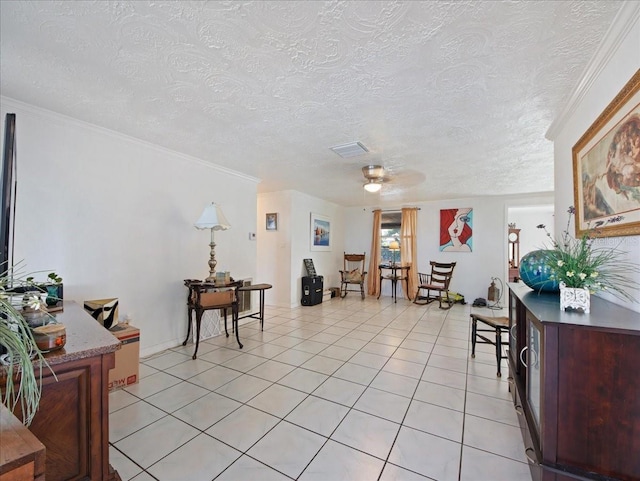 interior space with visible vents, a textured ceiling, light tile patterned flooring, and crown molding
