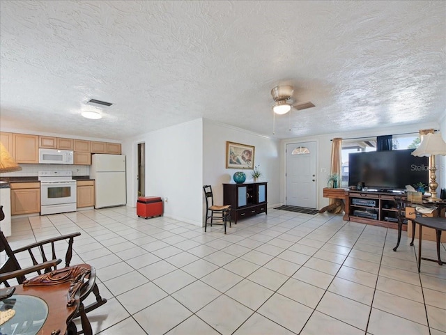 living room featuring light tile patterned floors, visible vents, a ceiling fan, and ornamental molding