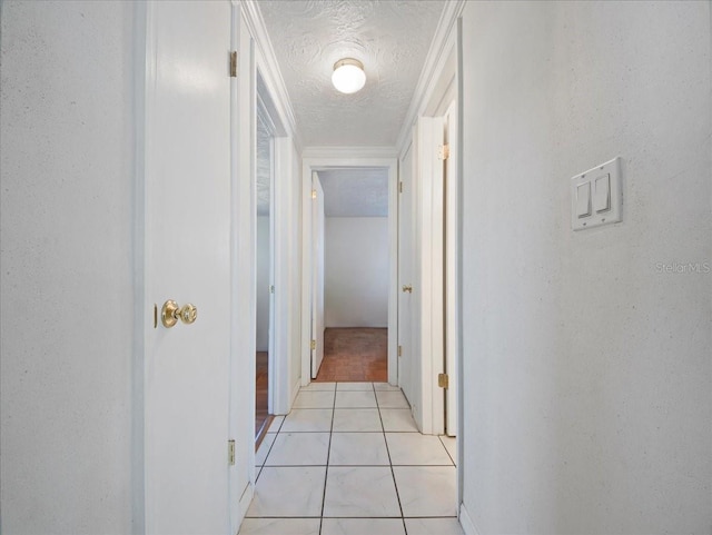 corridor with light tile patterned floors and a textured ceiling