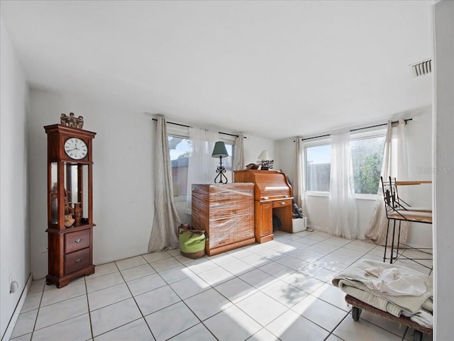 bedroom featuring light tile patterned floors, visible vents, and multiple windows