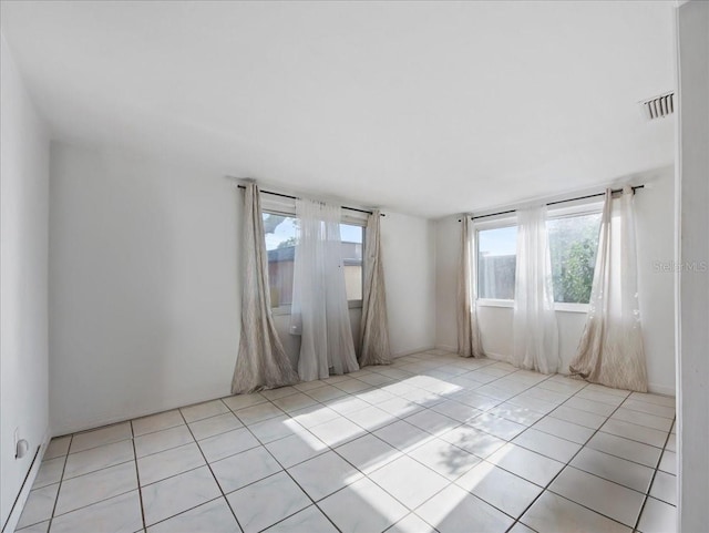 empty room featuring tile patterned floors and visible vents