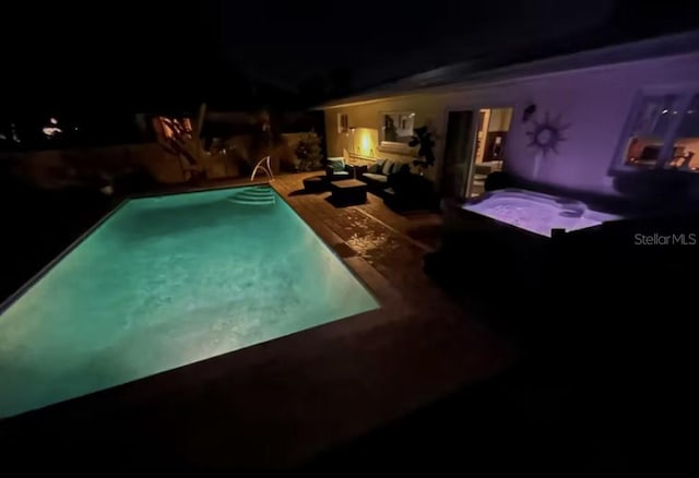 pool at twilight featuring an outdoor pool, outdoor lounge area, a hot tub, and a patio