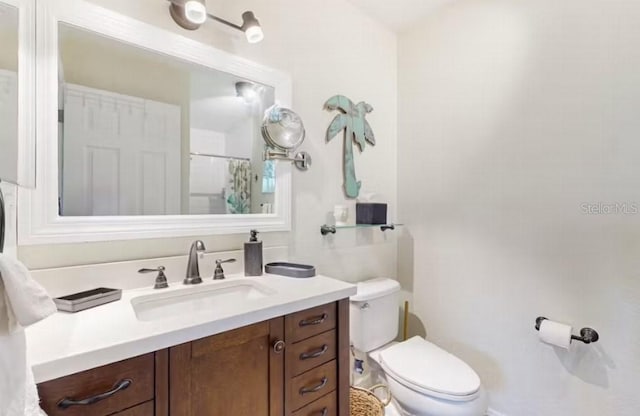 full bathroom with vanity and toilet