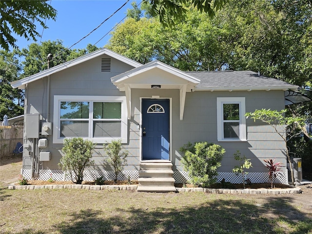 bungalow-style house featuring entry steps and roof with shingles