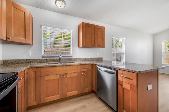 kitchen with range with electric cooktop, stainless steel dishwasher, a sink, light wood-type flooring, and a peninsula