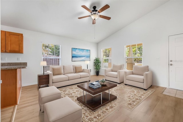 living area with light wood finished floors, high vaulted ceiling, and ceiling fan
