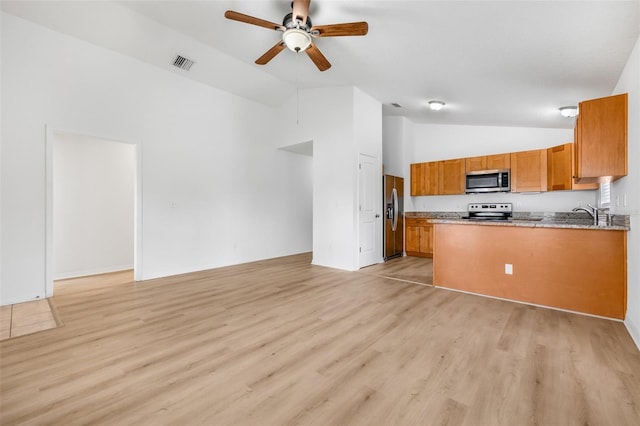 kitchen featuring a ceiling fan, brown cabinets, open floor plan, appliances with stainless steel finishes, and visible vents