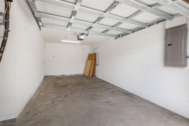 garage featuring concrete block wall, electric panel, and a garage door opener