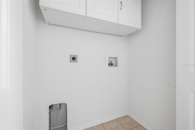 washroom featuring baseboards, hookup for a washing machine, cabinet space, electric dryer hookup, and light tile patterned floors