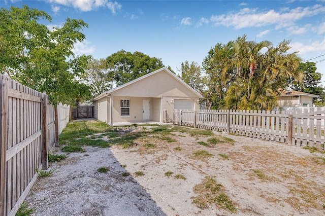 view of front of property with a garage and a fenced backyard