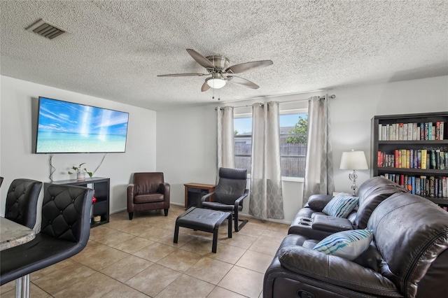 living room with visible vents, a ceiling fan, a textured ceiling, and tile patterned floors