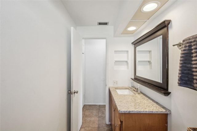 bathroom featuring vanity, baseboards, tile patterned floors, and visible vents
