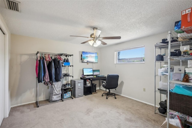 office area featuring carpet floors, a ceiling fan, a textured ceiling, and visible vents