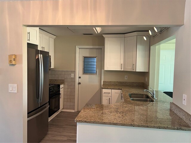 9825 41st St N, Pinellas Park, FL 33782 - kitchen featuring range, light stone countertops, a sink, freestanding refrigerator, and white cabinetry
