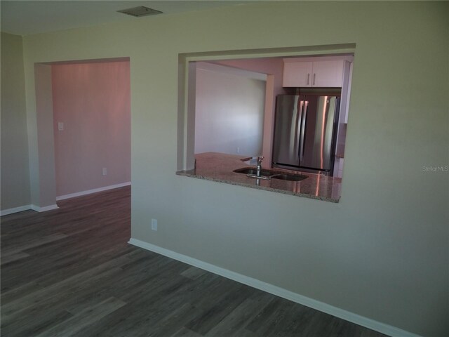 9825 41st St N, Pinellas Park, FL 33782 - empty room featuring a sink, baseboards, and dark wood-style floors