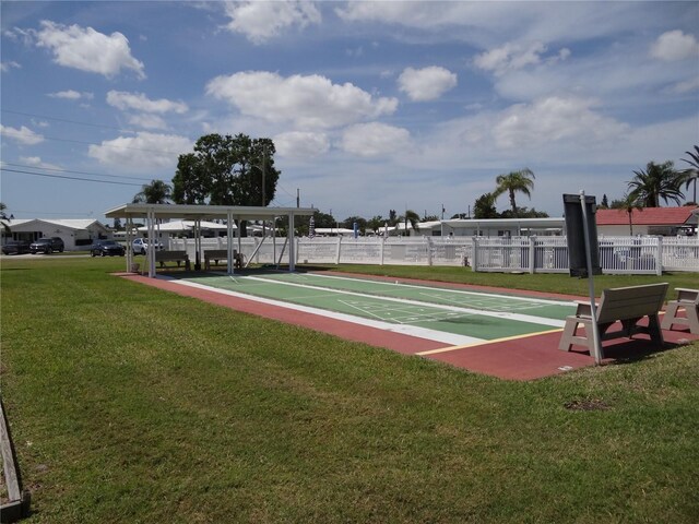 9825 41st St N, Pinellas Park, FL 33782 - view of home's community with fence, a lawn, and shuffleboard