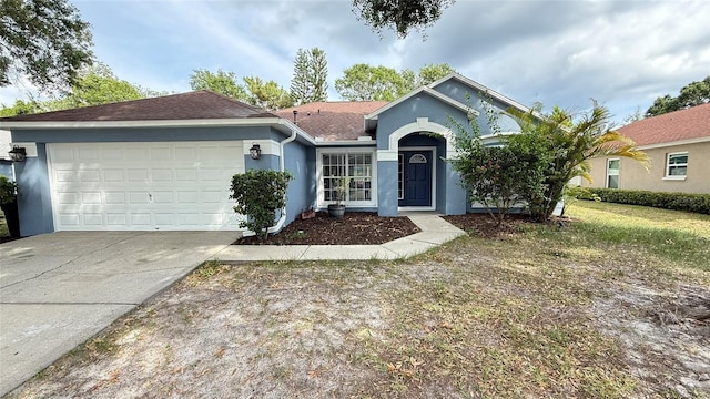 28818 Midnight Star Loop, Wesley Chapel, FL 33543 - single story home with stucco siding, an attached garage, concrete driveway, and roof with shingles
