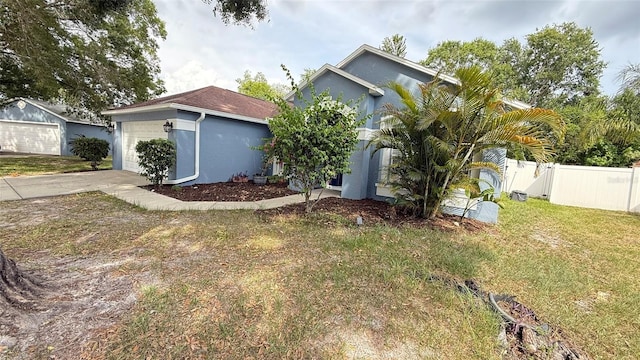 28818 Midnight Star Loop, Wesley Chapel, FL 33543 - view of front of property featuring stucco siding, an attached garage, and concrete driveway