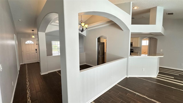 28818 Midnight Star Loop, Wesley Chapel, FL 33543 - foyer featuring baseboards, dark wood-type flooring, a chandelier, arched walkways, and recessed lighting