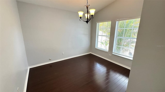 28818 Midnight Star Loop, Wesley Chapel, FL 33543 - empty room featuring a chandelier, baseboards, dark wood-type flooring, and vaulted ceiling