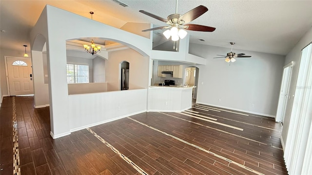 28818 Midnight Star Loop, Wesley Chapel, FL 33543 - unfurnished living room with lofted ceiling, ceiling fan, arched walkways, dark wood-type flooring, and baseboards