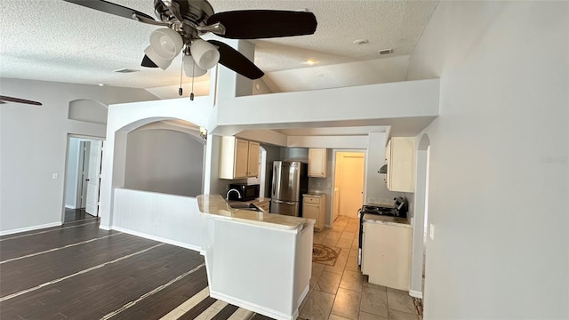28818 Midnight Star Loop, Wesley Chapel, FL 33543 - kitchen featuring freestanding refrigerator, stove, ceiling fan, a textured ceiling, and a sink
