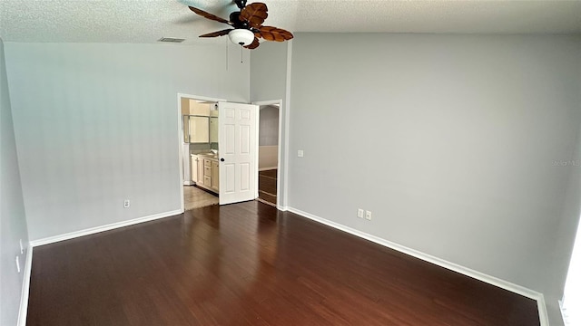 28818 Midnight Star Loop, Wesley Chapel, FL 33543 - unfurnished bedroom with lofted ceiling, dark wood finished floors, baseboards, a ceiling fan, and a textured ceiling