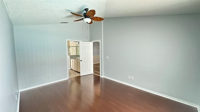28818 Midnight Star Loop, Wesley Chapel, FL 33543 - unfurnished bedroom with lofted ceiling, dark wood-type flooring, a textured ceiling, baseboards, and ceiling fan