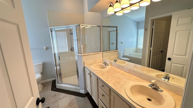 28818 Midnight Star Loop, Wesley Chapel, FL 33543 - bathroom with toilet, a garden tub, a shower stall, double vanity, and baseboards