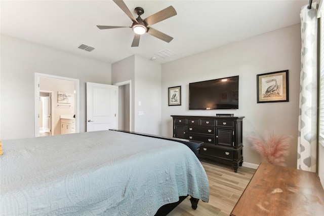 bedroom with light wood finished floors, baseboards, visible vents, ceiling fan, and ensuite bath