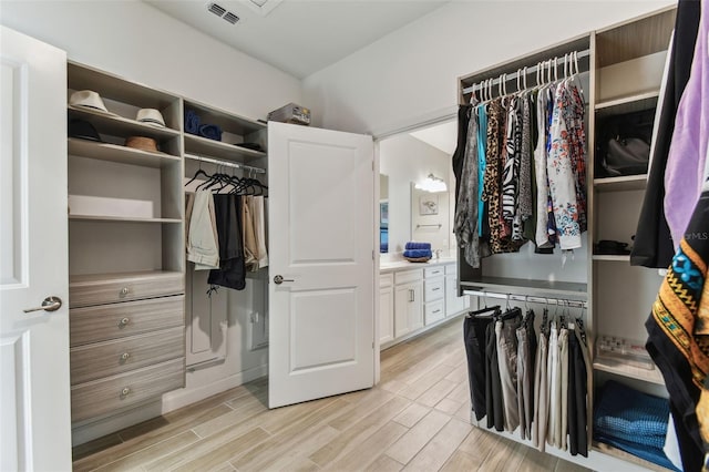 spacious closet with light wood-style floors and visible vents