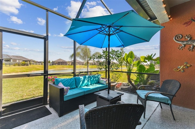 sunroom featuring a wealth of natural light, outdoor lounge area, and a water view