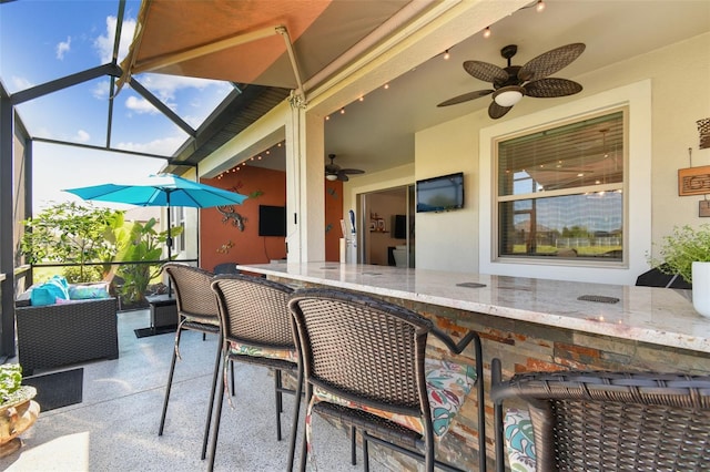 sunroom / solarium featuring outdoor dry bar, a ceiling fan, and an outdoor hangout area