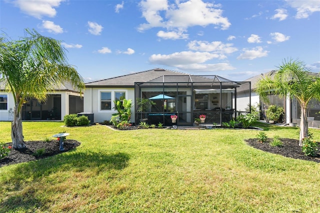 rear view of property featuring a lawn, central AC unit, glass enclosure, and stucco siding