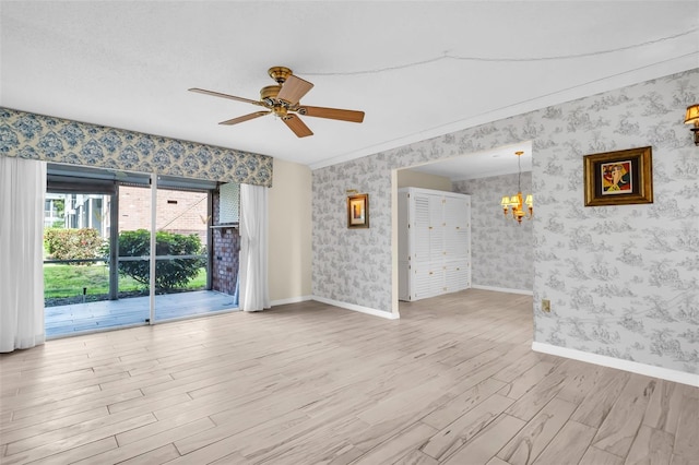 unfurnished room with light wood finished floors, a chandelier, wallpapered walls, a ceiling fan, and baseboards
