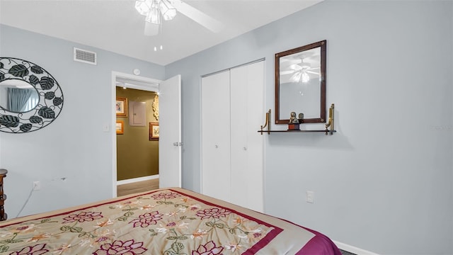 bedroom with a closet, baseboards, and a ceiling fan