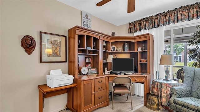 office space with ceiling fan and light carpet