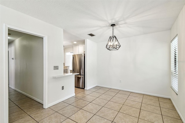 unfurnished dining area with baseboards, visible vents, light tile patterned flooring, and plenty of natural light