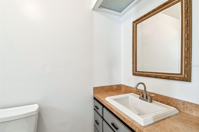 half bathroom featuring toilet and vanity